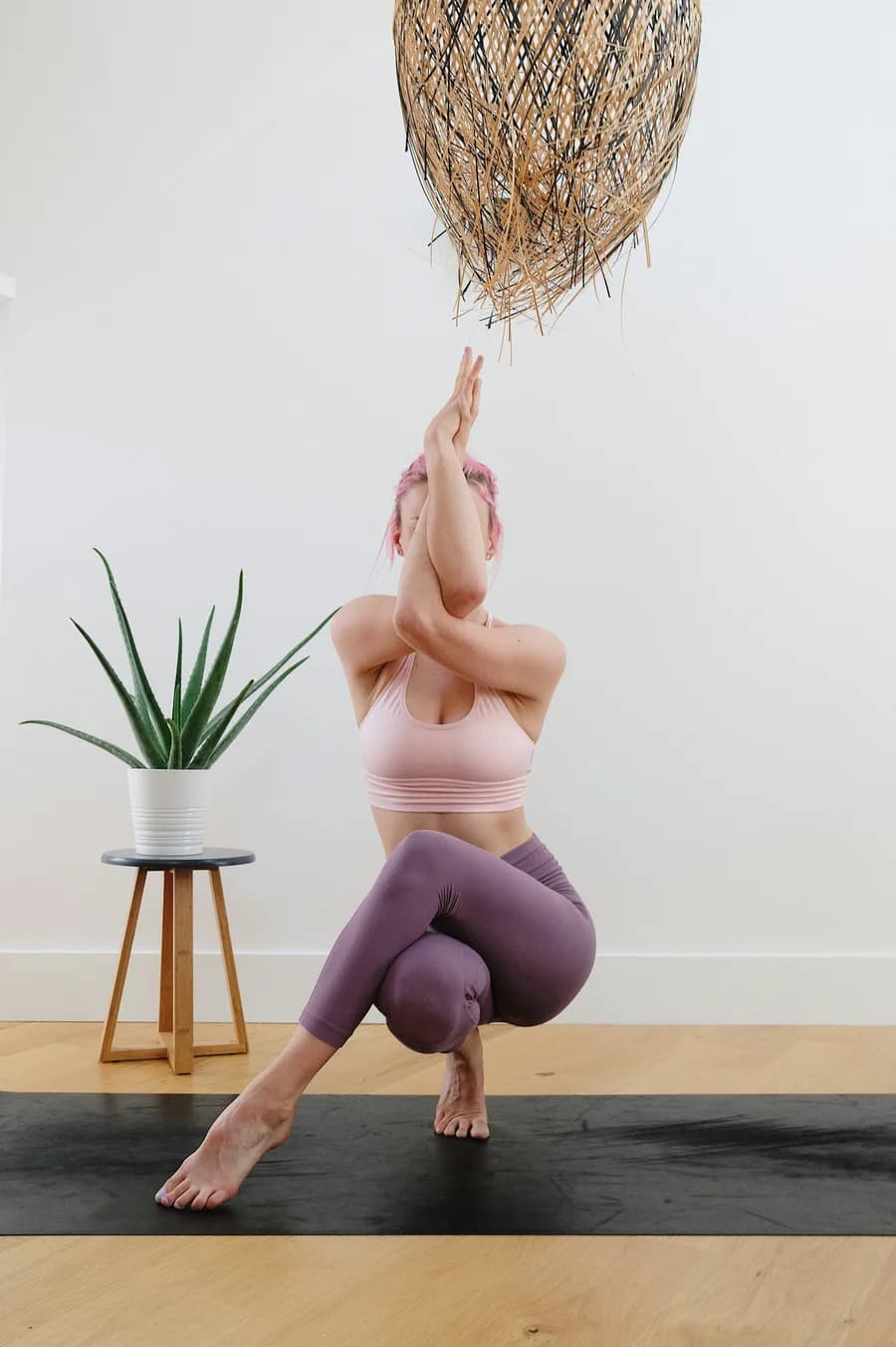 A calm, grounded stretch in a light, plant-filled room